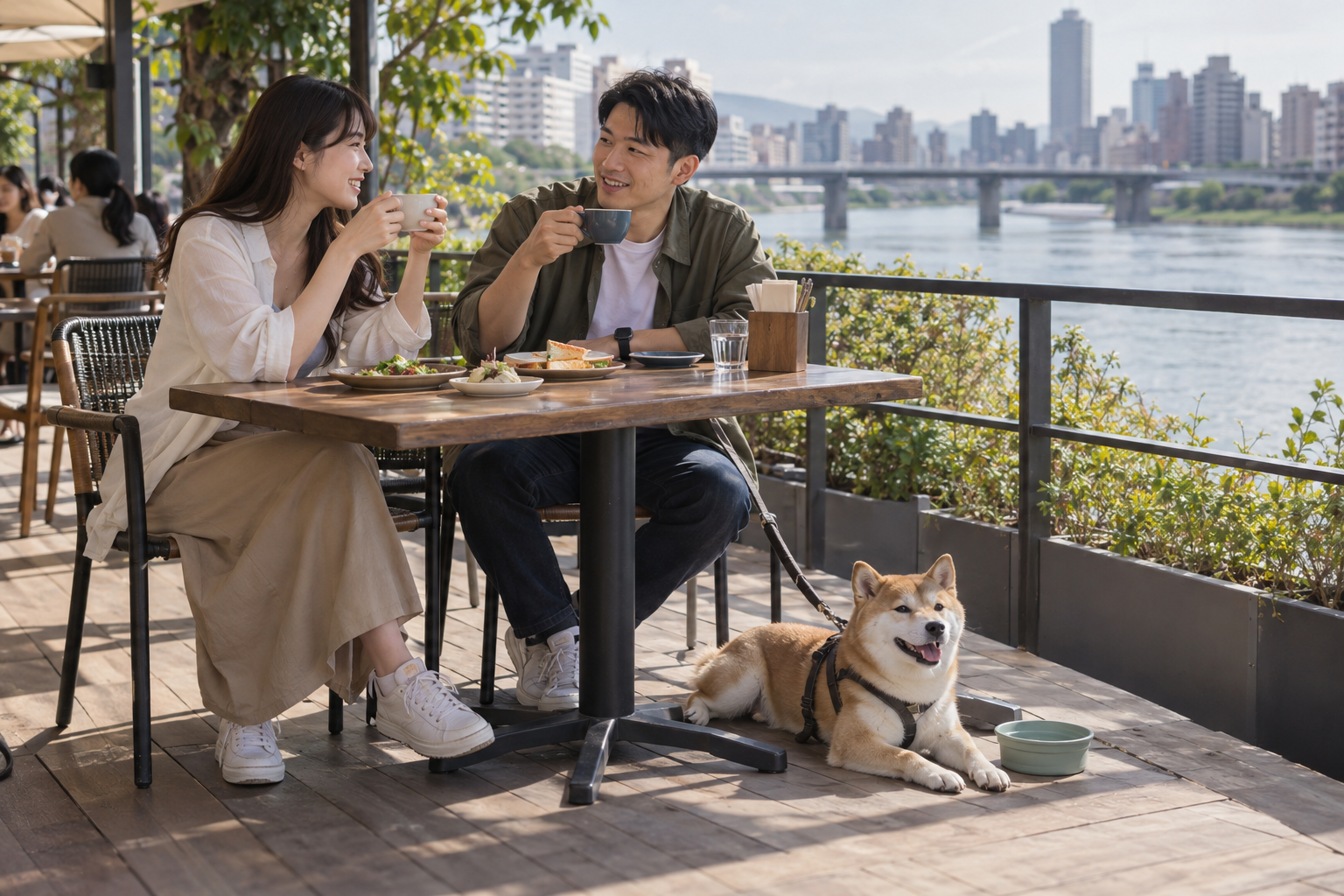 飼主與狗狗在河景咖啡館用餐的情境照片